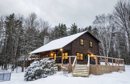 Jericho House | Woodlands: Luxury Vermont log cabin with sweeping views of field and forest.
