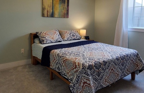 Williston North Condo | Basement Space with bedroom, living room, movie theatre and gym.