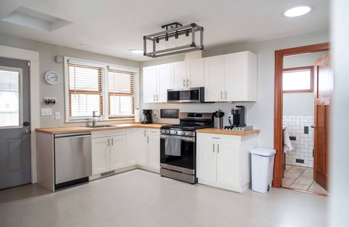 Midway House | Follow the Yellow Front Door to a welcoming home close to everything.