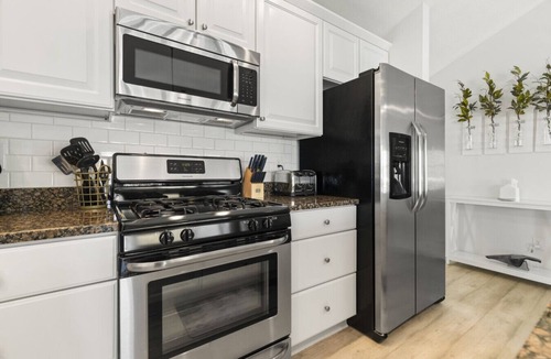 Beulah House | Modern-coastal retreat with lake views, covered deck, and walkable downtown Beulah location.