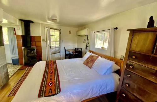 San Cristobal House | Petite Log Cabin on Organic Farm in New Mexico
