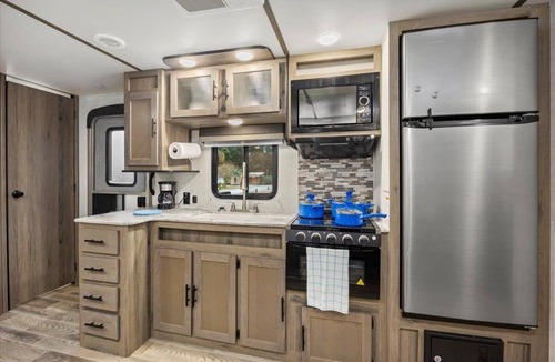 Milton RV Rental | Super- fun camper with plenty of room for a full-size family, lots of comfy beds + full kitchen, bath, and separate bedroom for Mom & Dad. There's even a nice patio with outdoor kitchen and seating area for barbecues, bacon & eggs in the morning, et
