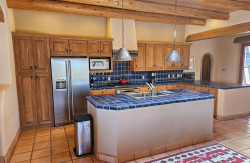 Arroyo Seco House | Sweeping panoramic mountain views, expansive adobe privacy wall system