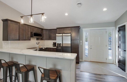 Cumberland Condo | Up North Living! Fully renovated one-level living home in wooded lot near lake.