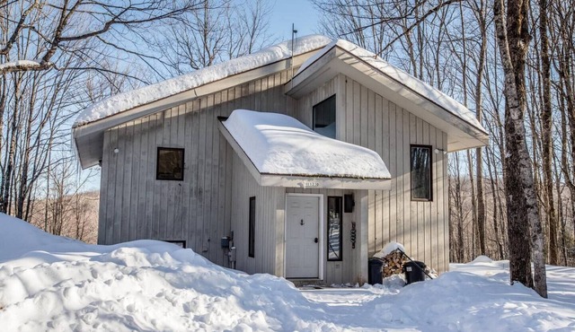 A Spacious Vacation Home in a Wooded Setting With A Brick Fireplace