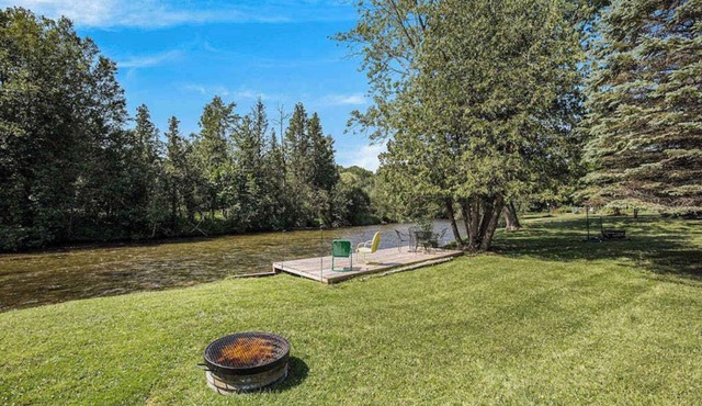 Riverfront cabin with furnished deck, beautiful backyard, firepit & kayaks